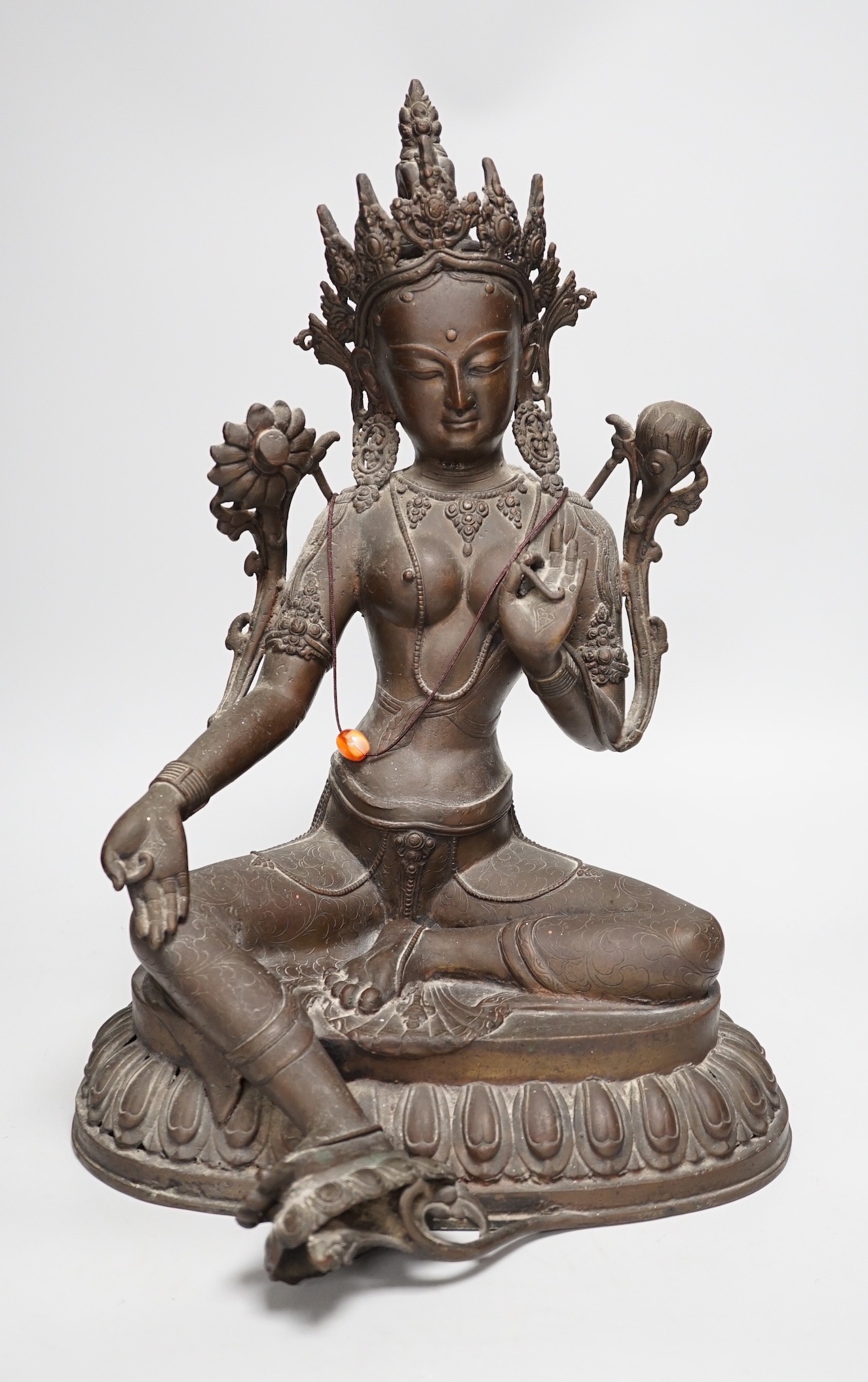 A Buddhist bronze seated figure of Green Tara. 42cm tall